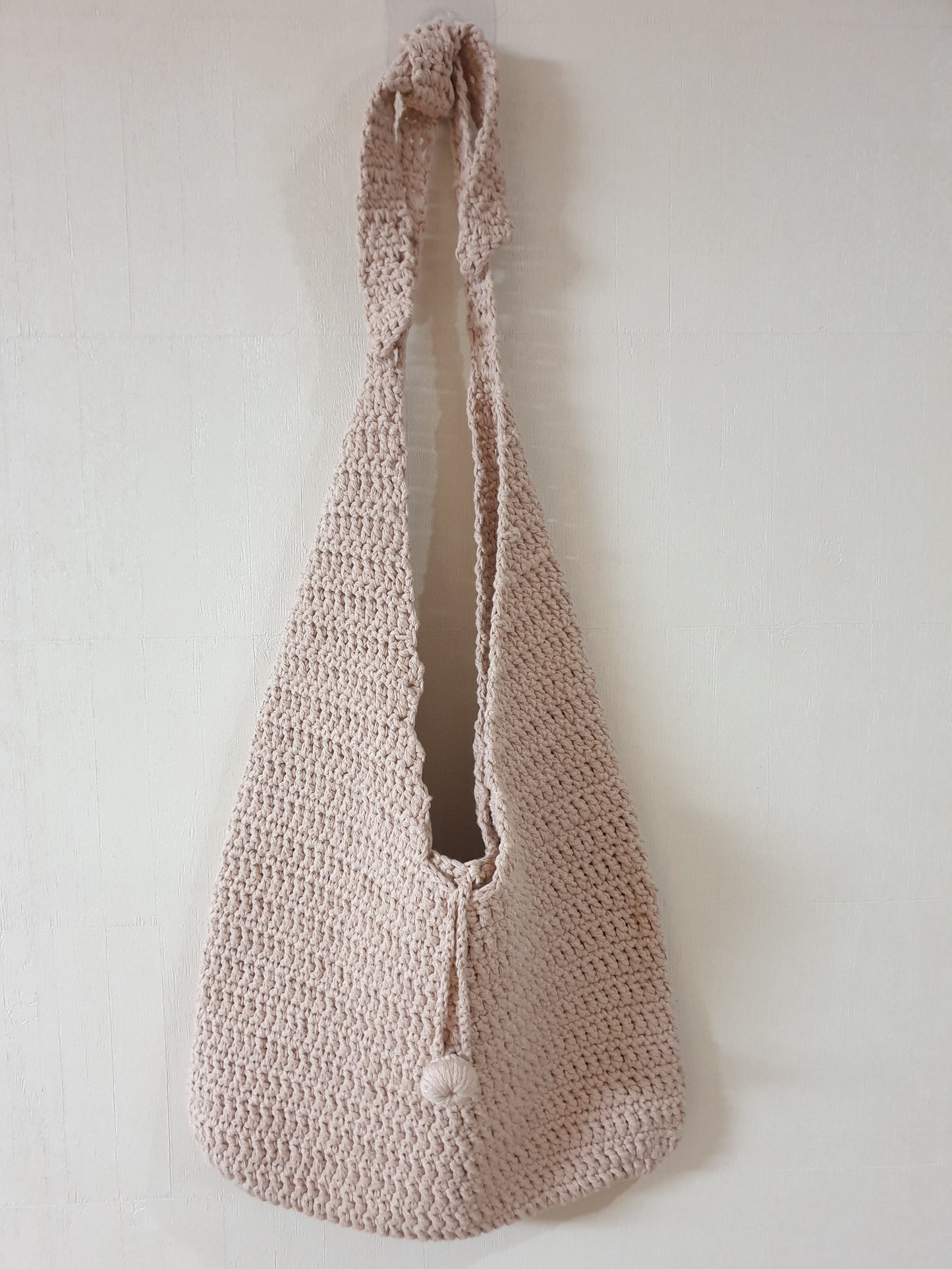 A bag which is made with beige color tube yarns. (Using two balls(two yarns) at once, to make thick bag.)